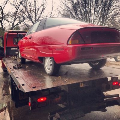 Unregistered show car being towed by a fast Emergency Roadside Assistance tow truck in Worcester MA 