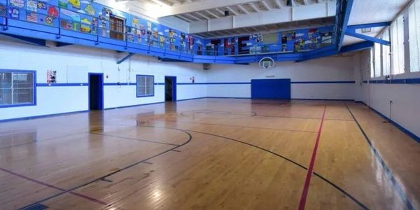 Y Lofts Senior Apartments Gymnasium with indoor basketball court and indoor running track