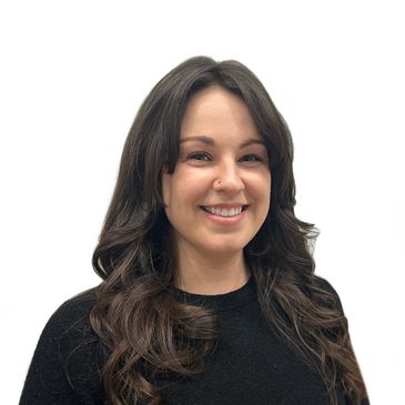 Smiling woman with long wavy hair wearing a black top.