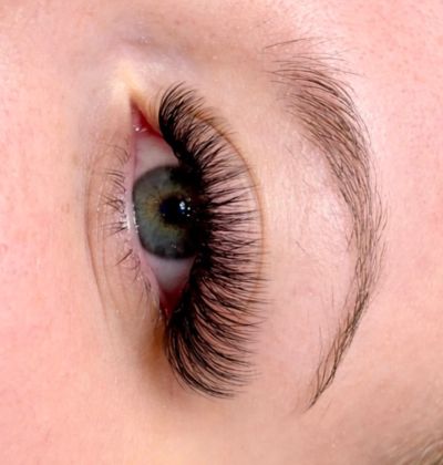 Close-up of an eye with long, thick eyelash extensions.