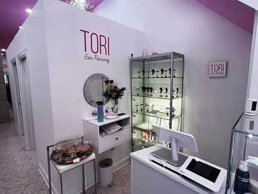 Interior of TORI Ear Piercing shop with displays and reception.