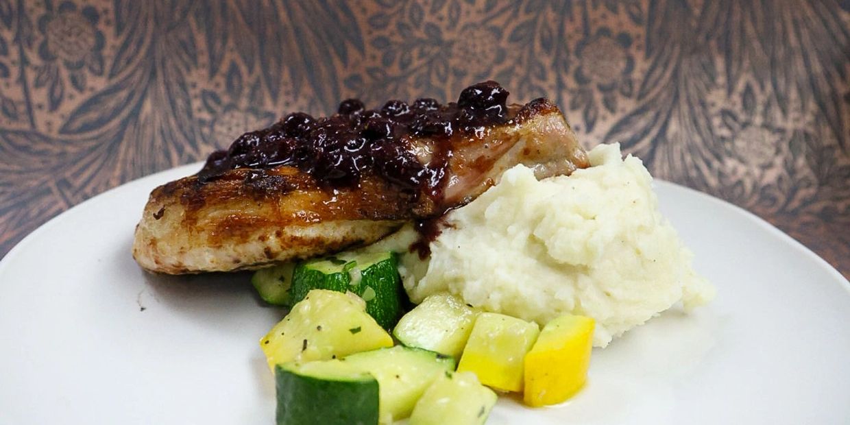 Grilled chicken with mashed potatoes and sautéed zucchini.