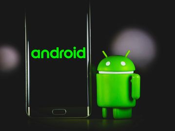 Android logo displayed on a smartphone next to a green Android mascot figure.