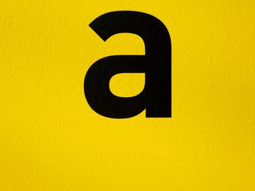 Lowercase letter 'a' in black on a bright yellow background.