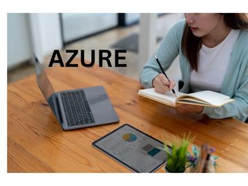 Person writing in a notebook with laptop and tablet on wooden desk, word 'AZURE' overlayed.