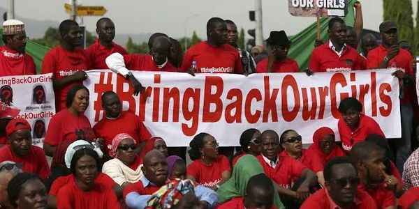 Protesters holding a #BringBackOurGirls banner.