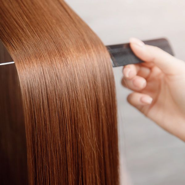 red head feamle with silky smooth hair from keratin treatment 
