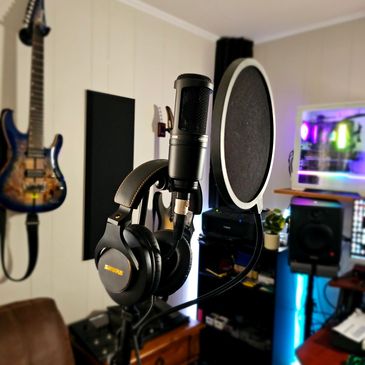 A microphone and a set of headphones on a stand.