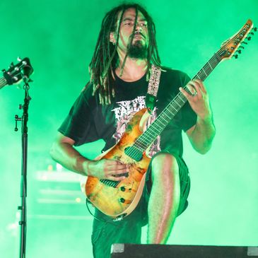A musician performing live on a stage.