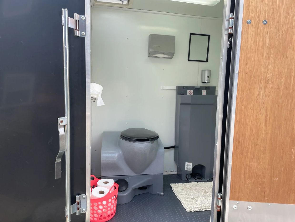 XL Portable bathroom is large enough for an adult to accompany a child.  Features a light,  running 