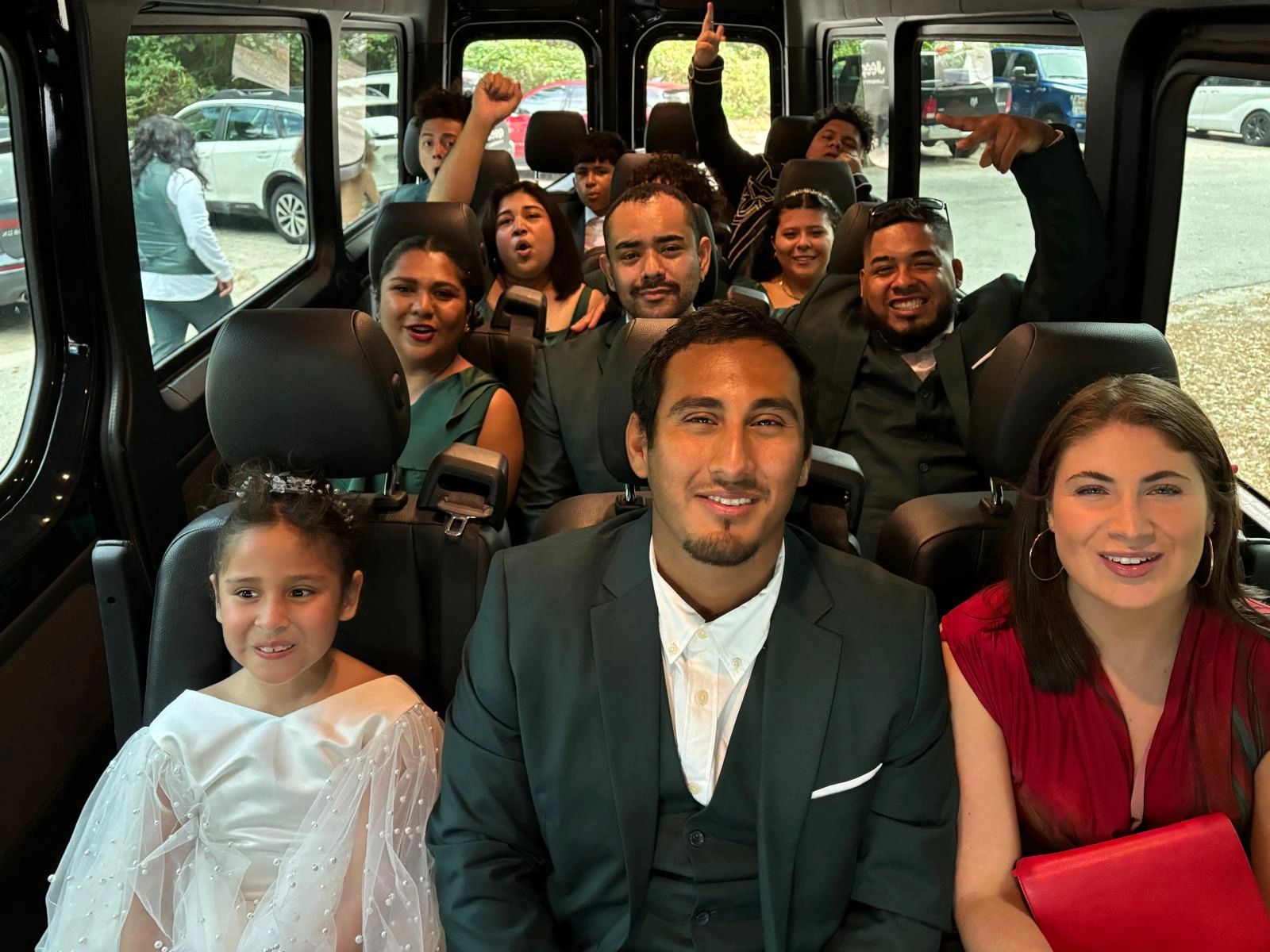 Groomsmen, Bridesmaids and wedding guests travel from the church to the reception in a Sprinter Van
