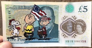 Five-pound note with Peanuts cartoon characters.