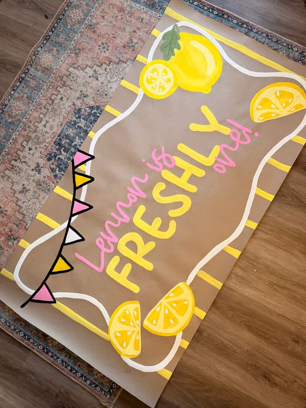 Colorful poster with lemons and text saying "Lemon is FRESHLY one!".