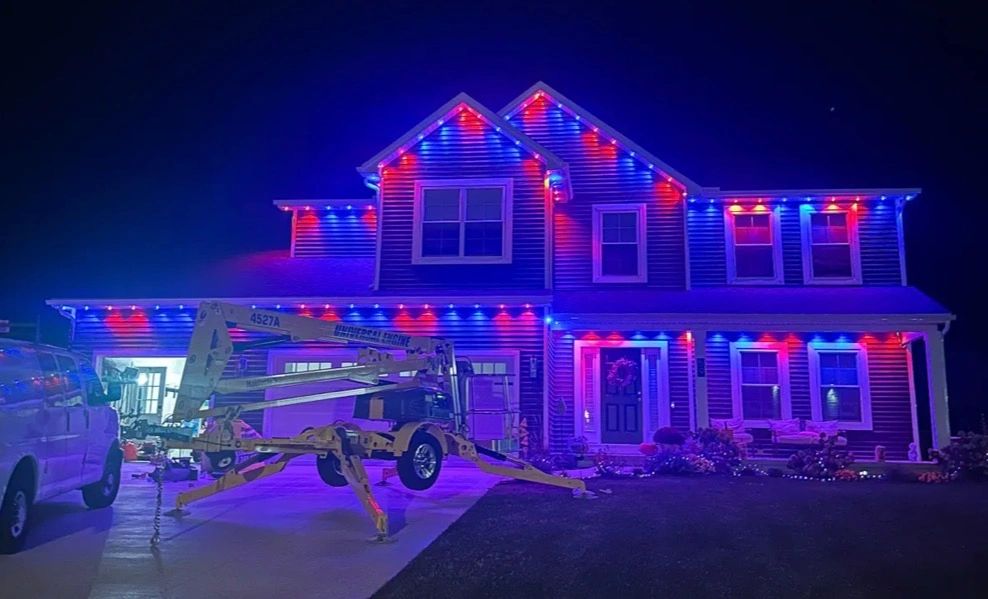 A house decorated with red and blue lights at night.