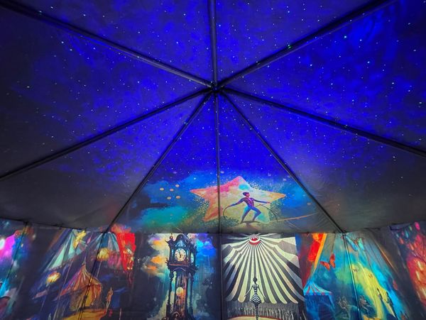 immersive tent for celebration, event production, immersive art with images of circus figures