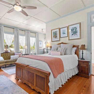 Bright vintage bedroom with wooden floor and antique furniture.