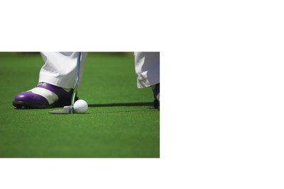 Golfer putting a ball on the green with purple and white shoes.