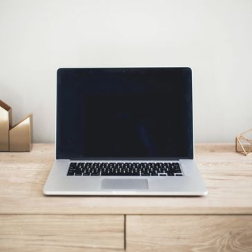 Computer sitting on a desk with decorations surrounding it.