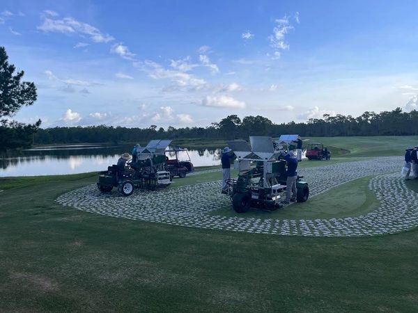 Drill and Fill Aerator machines drilling and backfilling on The Concession Golf Club green.