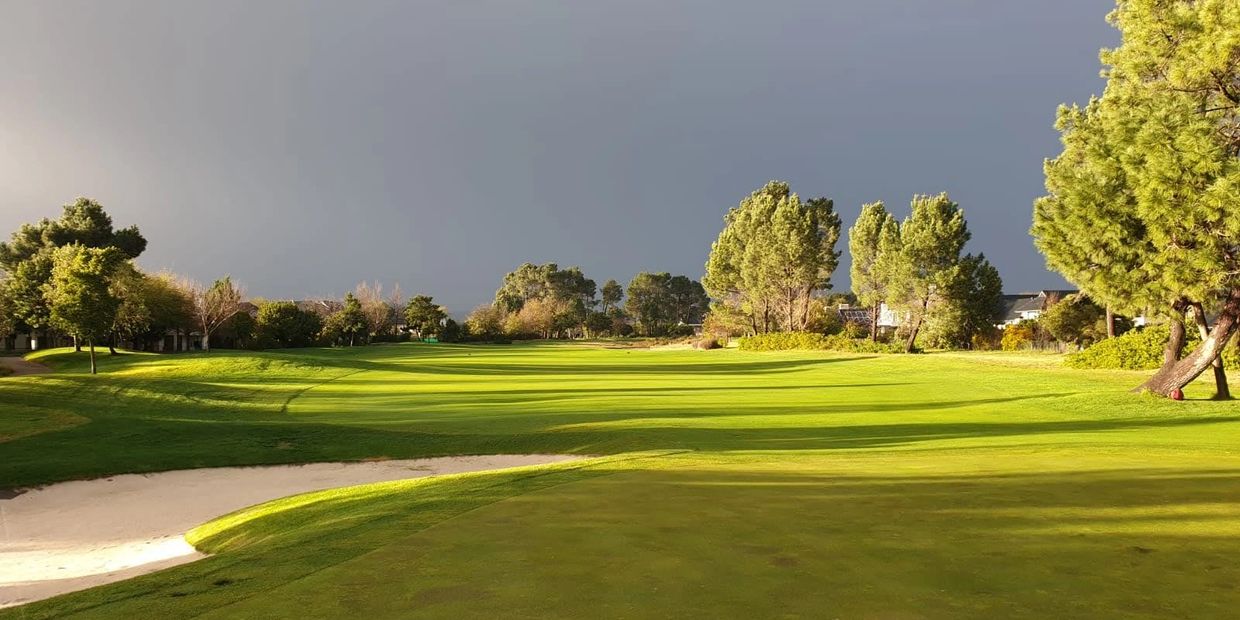 Golf Course with dark clouds in the background.