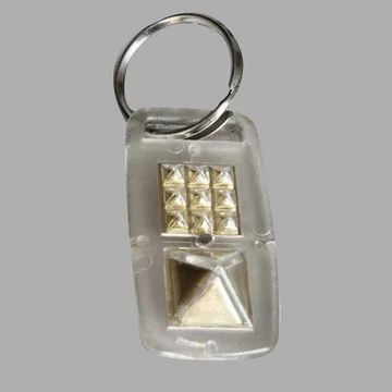 Transparent keychain with metallic pyramid decorations.