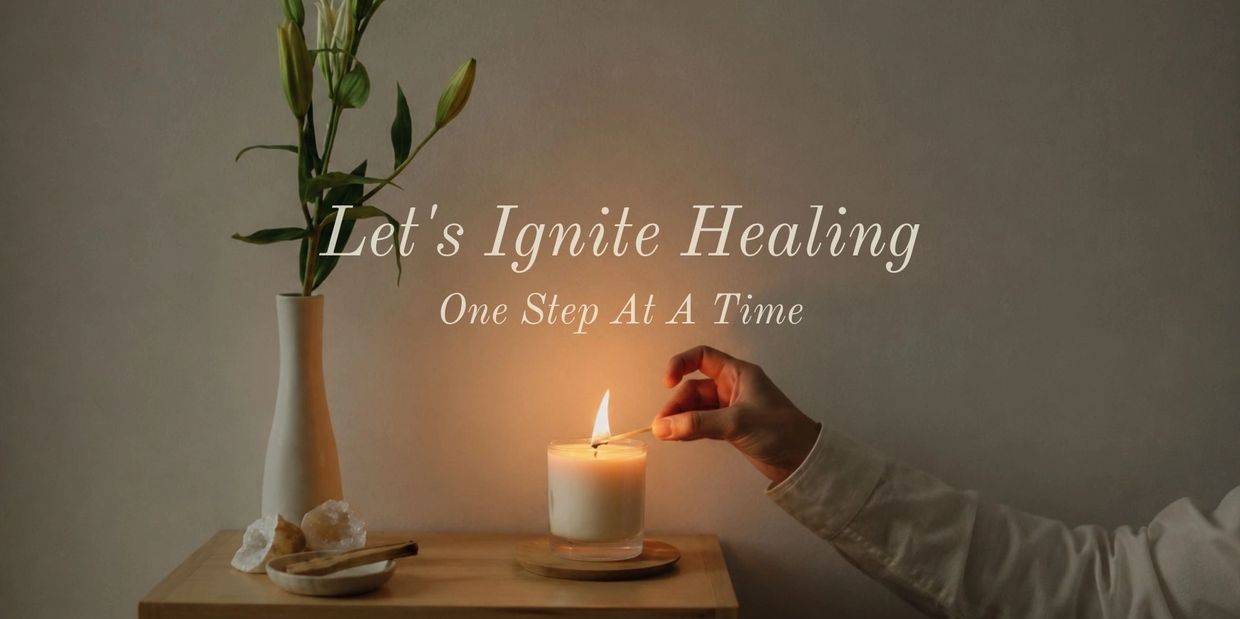 A hand lights a candle with a match, next to a vase with flowers and crystals.