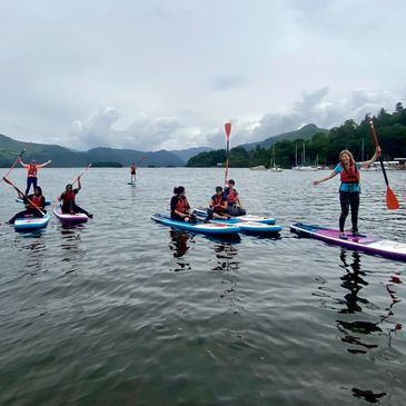 Group of women Paddleboarding on lake in the Lake District, uk