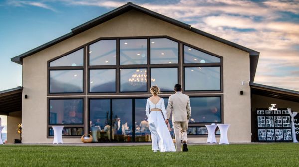Bride and groom walking to a modern wedding venue.