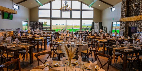 Tables decorated for a wedding in the indoor event space.