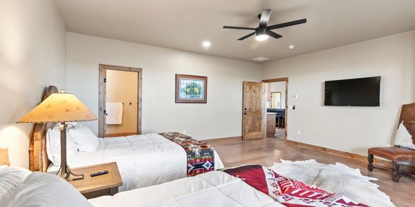 Cozy bedroom with two beds and rustic decor.