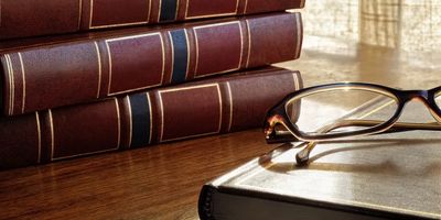 law books with glasses on a book