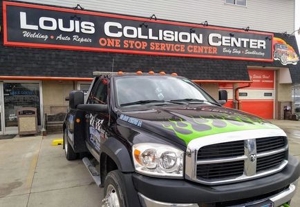 One of the 24 hour tow trucks. This one with cool green flames painted on the hood.