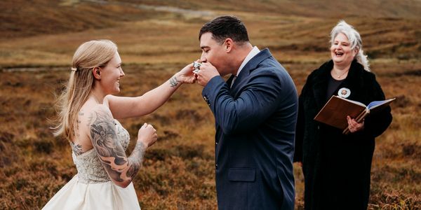 American couple elopement at Glencoe with Scottish quaich. Elopement photography by Laura Kemp.