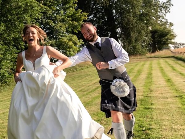 fun couple running in the grounds of cornhill castle image captured by Pearl and Plum Photography