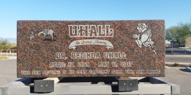 Gravestone of Dr. Belinda Unall with detailed engravings and a rose illustration.