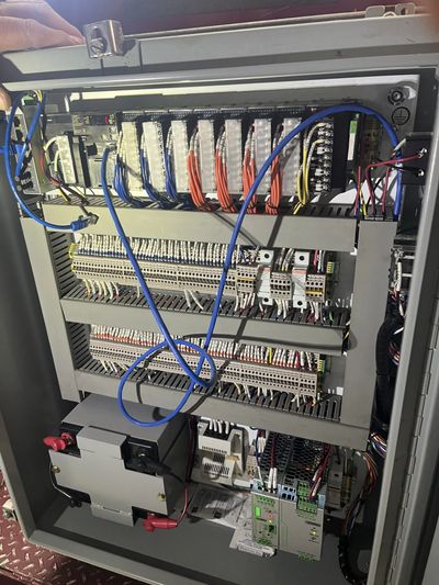 Open electrical control panel with organized wiring and components.