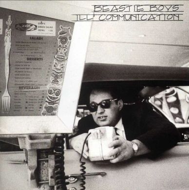Black and white photo of a man in sunglasses at a drive-thru window, holding a container.