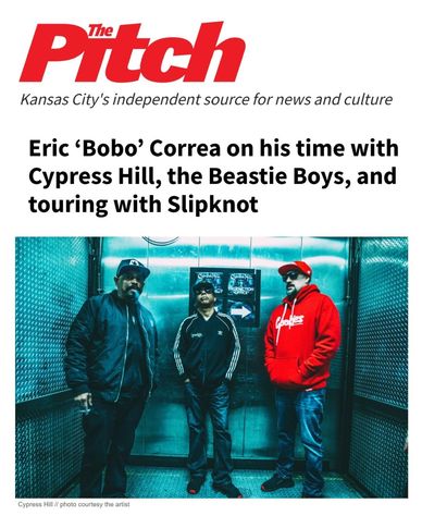 Three men posing in a metallic elevator, related to a music interview with Eric 'Bobo' Correa.
