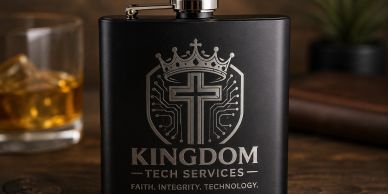 Black flask with Kingdom Tech Services logo and tagline on a wooden table.