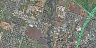 Aerial view of a suburban area with parks, schools, and commercial establishments.