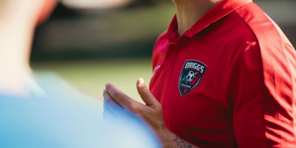 Person wearing a red Briggs Soccer shirt.