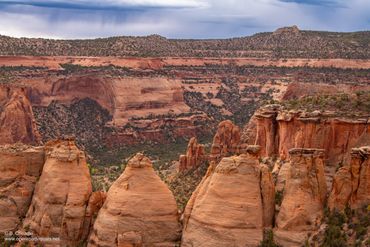 Scenic view of rugged red rock formations under a cloudy sky.