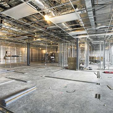 Interior of a building under construction with exposed framework and ceiling.