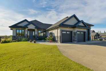 Modern suburban house with a manicured lawn and double garage.