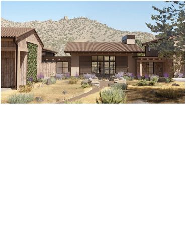 Modern rustic house with desert landscaping and mountain backdrop.
