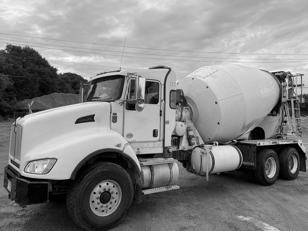Rear-discharge mixer truck. Rear-discharge concrete mixing truck. Concrete mixer truck.