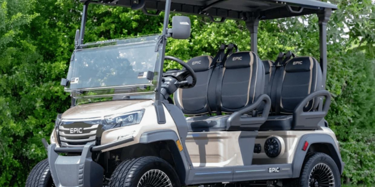 2026 EPIC E40FX four-passenger electric golf cart in champagne gold with black and tan leather seats