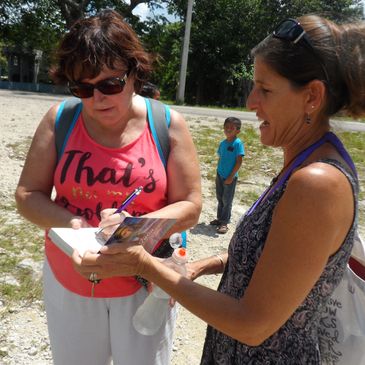 Ann Jagger signs an autograph for a fan in Punta Laguna, Yucatan, Mexico.