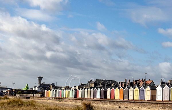 Great Yarmouth beach huts, displaying vibrant colours on the parade. 