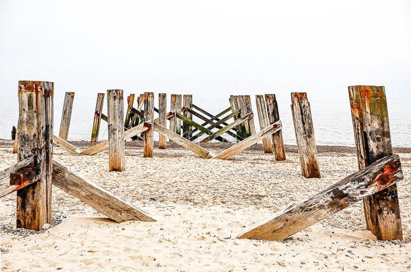 Great Yarmouth beach 'rustic legs standing strong' old Wellington pier leading into the North sea. 